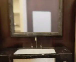 Where am I and any reflections in that mirror.webp